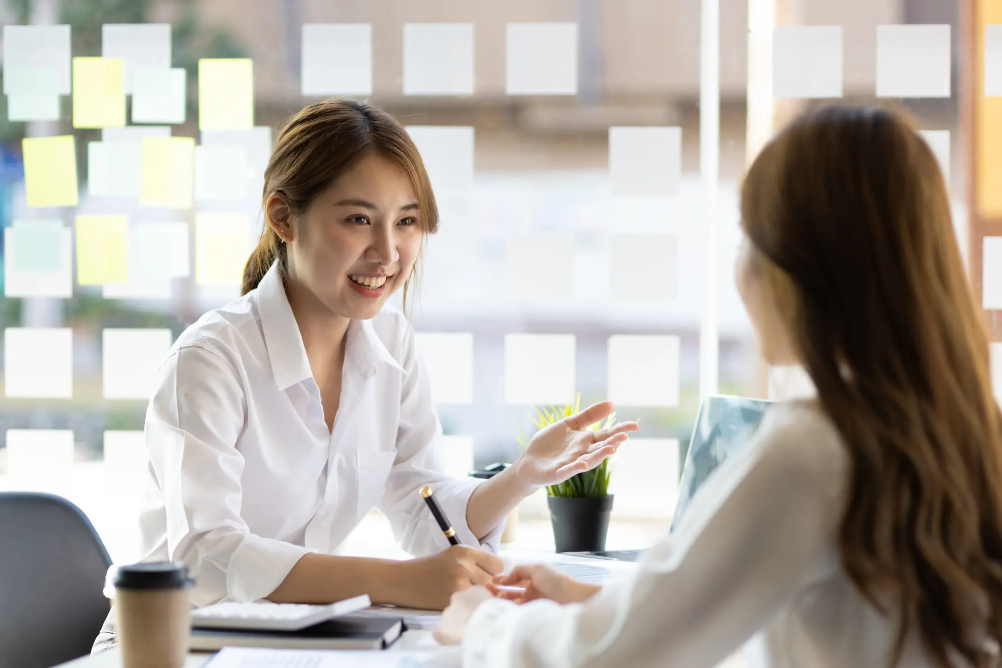 two-female-colleagues-discuss-start-up-projects